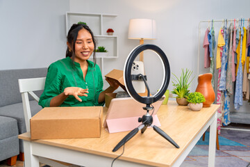 Latin influencer unboxing products and recording video for social media