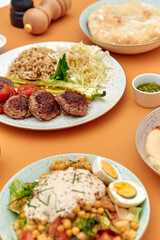 A Beautifully Arranged Platter of Savory Dishes Highlighting Juicy Patties, Fresh Vegetables, and Flavorful Sides Perfect for a Flavorful Feast