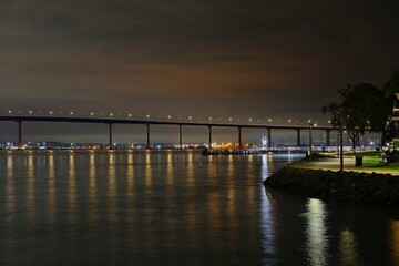Fototapeta premium The San Diego-Coronado Bridge rises above the dark waters of the San Diego Bay