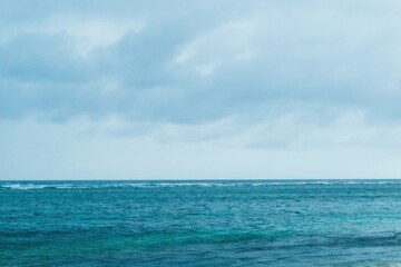 Stunning turquoise sea at Pandawa Beach under a dramatic black sky. A beautiful and moody day on...