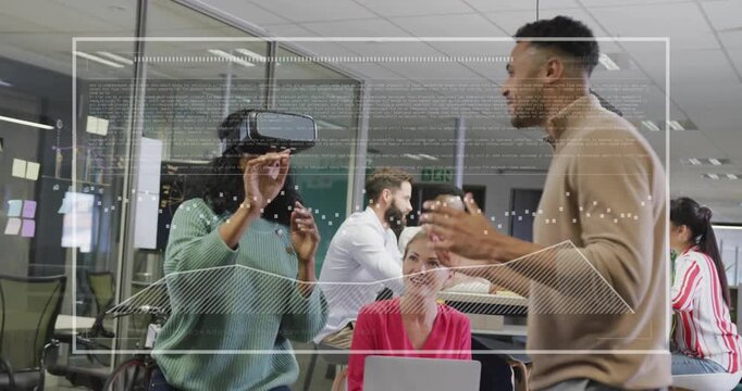 VR user lifting headset and pointing for demo while guide gesturing initiating data overlay