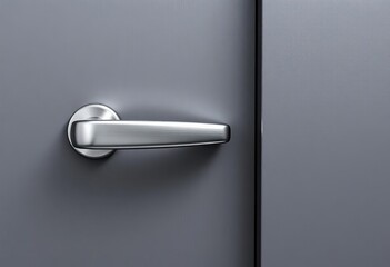 Sleek metallic door handle against a textured gray wall,  hardware,  gray wall