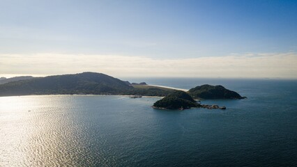 Drone view of Ilha do Mel, Paraná, Brazil, featuring ocean, small islands, and lush green hills.