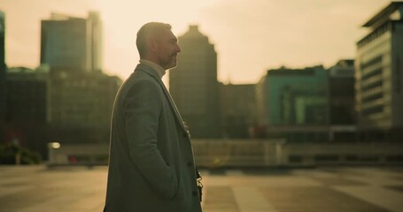Morning, thinking and business man in city on commute, travel and journey to work in urban town. Professional, corporate and mature person walking with sunrise for career, finance job and ambition - Powered by Adobe