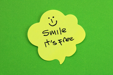 Sticky note with a happy face and the phrase Smile, it's free