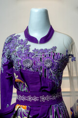 This purple wedding gown features intricate silver floral embroidery on the bodice, adorned with...