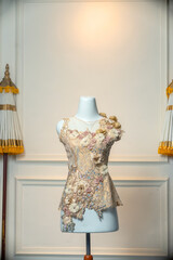 Front view of a luxurious sleeveless bridal dress with gold lace, floral embellishments, and gemstone details. Perfect for wedding promotions, fashion editorials, or boutique catalogs.