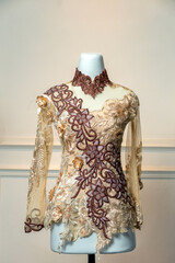 Luxurious wedding dress with long sleeves, featuring intricate brown floral embroidery and golden...