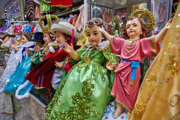 Dressed figures of the Infant Jesus (Nino Dios) displayed at Mercado Central in Ambato, Ecuador,...