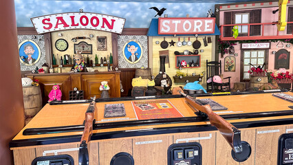 Amusement shooting gallery featuring a saloon, store, and hotel scene
