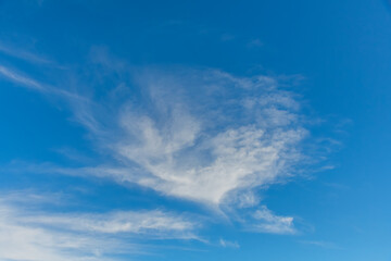 High cloud in the blue afternoon sky