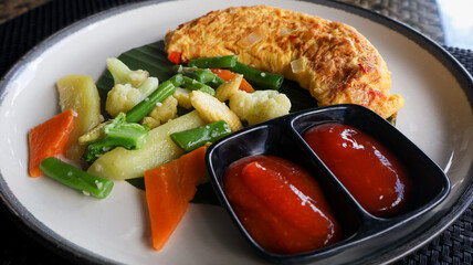 Golden fluffy omelette freshly cooked, filled with fresh ingredients, and served with vegetables and condiments. Culinary blogs, recipe illustrations, and food styling projects.