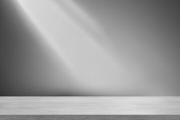 Empty  wooden table top with sunlight shadows on grey, gray wall. Natural warm background for...