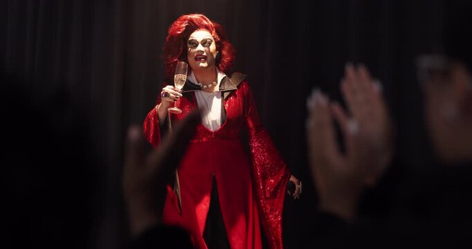Applause, champagne and stage with drag performer in theater for lgbt culture, nightlife and spotlight show. Identity, entertainment and winner with person at event for celebration and audience