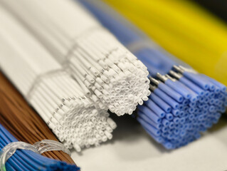 Colorful collection of various craft wires arranged neatly in a workspace showcasing creativity and...