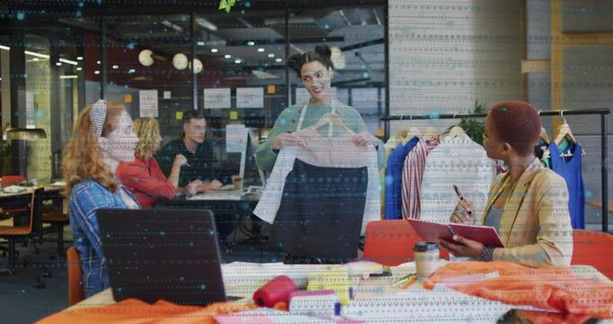 Woman selecting outfit and presenting garment in fashion review while colleagues recording feedback