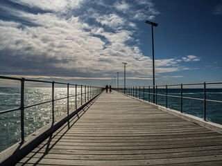 Naklejka premium View Up Rye Pier Into The Sun