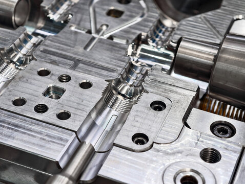 Metal molds used for precision plastic injection molding displayed in a manufacturing facility during daylight operations