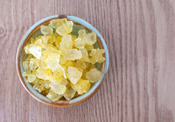 yellow rock sugar or crystal sugar on wooden table. top view