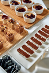 A Splendid Array of Gourmet Desserts Featuring Chocolate Bars, Creamy Puddings, and Fruit Toppings Perfect for Any Celebration or Indulgent Treat.