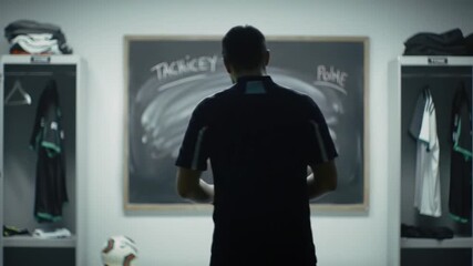 Soccer coach ponders game plan in locker room - Powered by Adobe