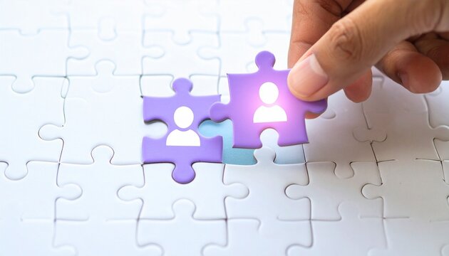 Connecting People: Hand Placing Puzzle Piece with a Human Silhouette to Complete the White Jigsaw, Symbolizing Teamwork and Collaboration
