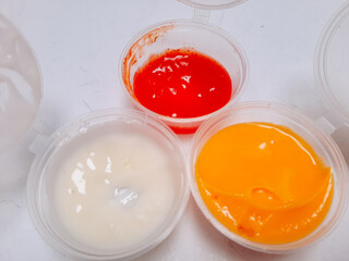 Bowl with cheese, tomato and mayonnaise sauce isolated on white background