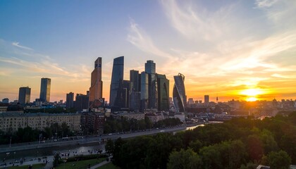 Obraz premium City skyline at sunset over a river (1)