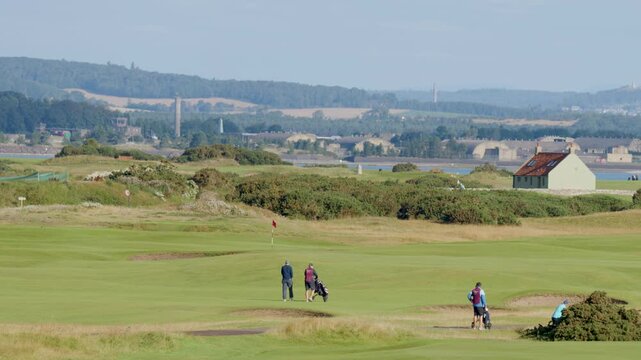 Golfers Walking Across Fairway at St Andrews Course