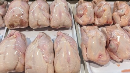 Cleaned, headless whole chickens, neatly packed and ready for sale at the Freshmart display.