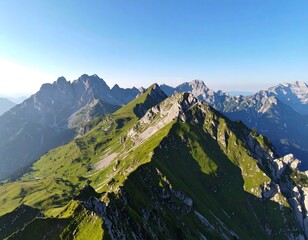 Panoramic view of sunlit mountain ridges and valleys