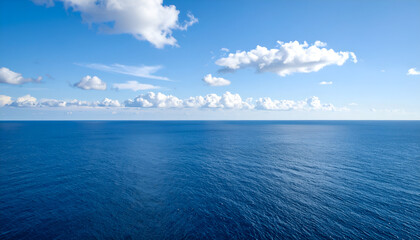 Obraz premium Calm Ocean with Blue Sky, and Cloudscape.