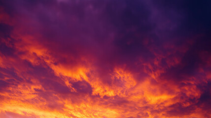 Dramatic sunrise with gradient orange and purple clouds, creating a panoramic abstract sky view.