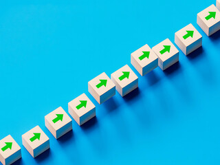 Obraz premium White cubes with green upward arrows arranged diagonally on a blue background
