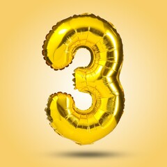 Shiny golden number three balloon on a bright yellow background. Ideal for birthday parties,...