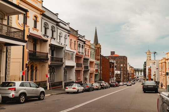 Row of three storey terrace houses along Newcastle street leading to Hunter River