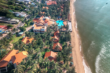 Golden Coast 4-star Resort - June 30, 2025: The resort is hidden among the coconut trees at the Golden Coast 4-star Resort, Phan Thiet, Binh Thuan Province, Vietnam. View from above