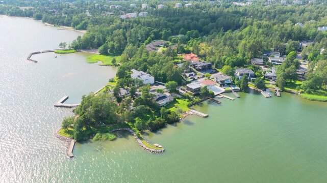 Aerial view circling upscale homes of Westend, summer day in Espoo, Finland