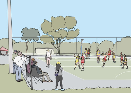 People sitting and standing on sidelines watching winter netball game