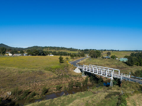 aerial image of Beckers Bridge crossing Webbers Creek in Glendon Brook on sunlit day