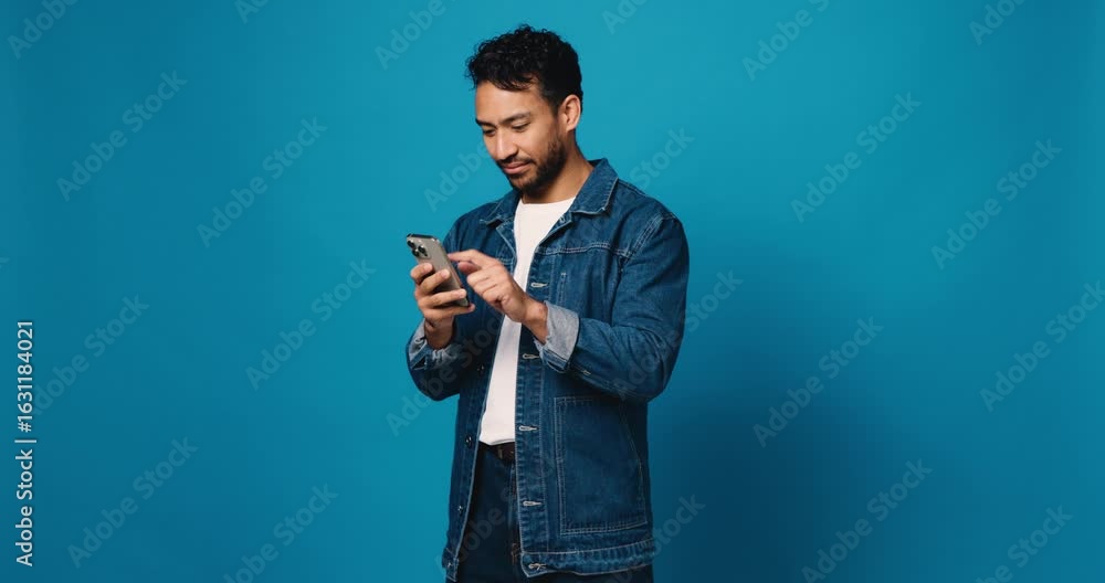 Wall mural scroll, phone and smile with man in studio for social media, text message and communication. connect