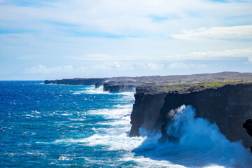 Powerful Ocean Waves Crash Against the Hōlei Sea Arch and Volcanic Lava Cliffs in Hawaii Volcanoes...