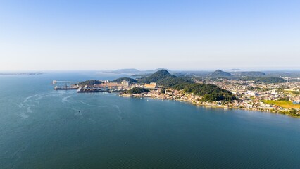 Expansive aerial view of São Francisco do Sul port and Babitonga Bay with mountains and sea under...