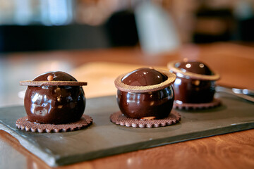 Decadent Chocolate Truffles Displayed Elegantly on a Slate Platter, Showcasing Artistry and...