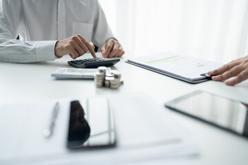 Businessman checking bills taxes bank account balance and calculating annual financial statements...