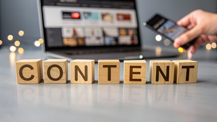 Content creation concept with wooden cubes, laptop, and smartphone for digital marketing and online business strategy on gray background