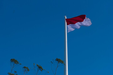 Indonesia national flag waving in blue sky