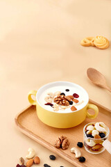 Delicious and Healthy Mixed Nuts and Seeds Bowl with Yogurt and Sweet Treats, Healthy breakfast with muesli, nuts and buns.