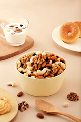 Creamy Yogurt with Nuts and Dried Fruits - Healthy Breakfast Bowl, Cup of tasty oatmeal with nuts and berries on color background