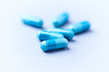 Amino acids capsules on bright background. Soft focus. Close up. Copy space.